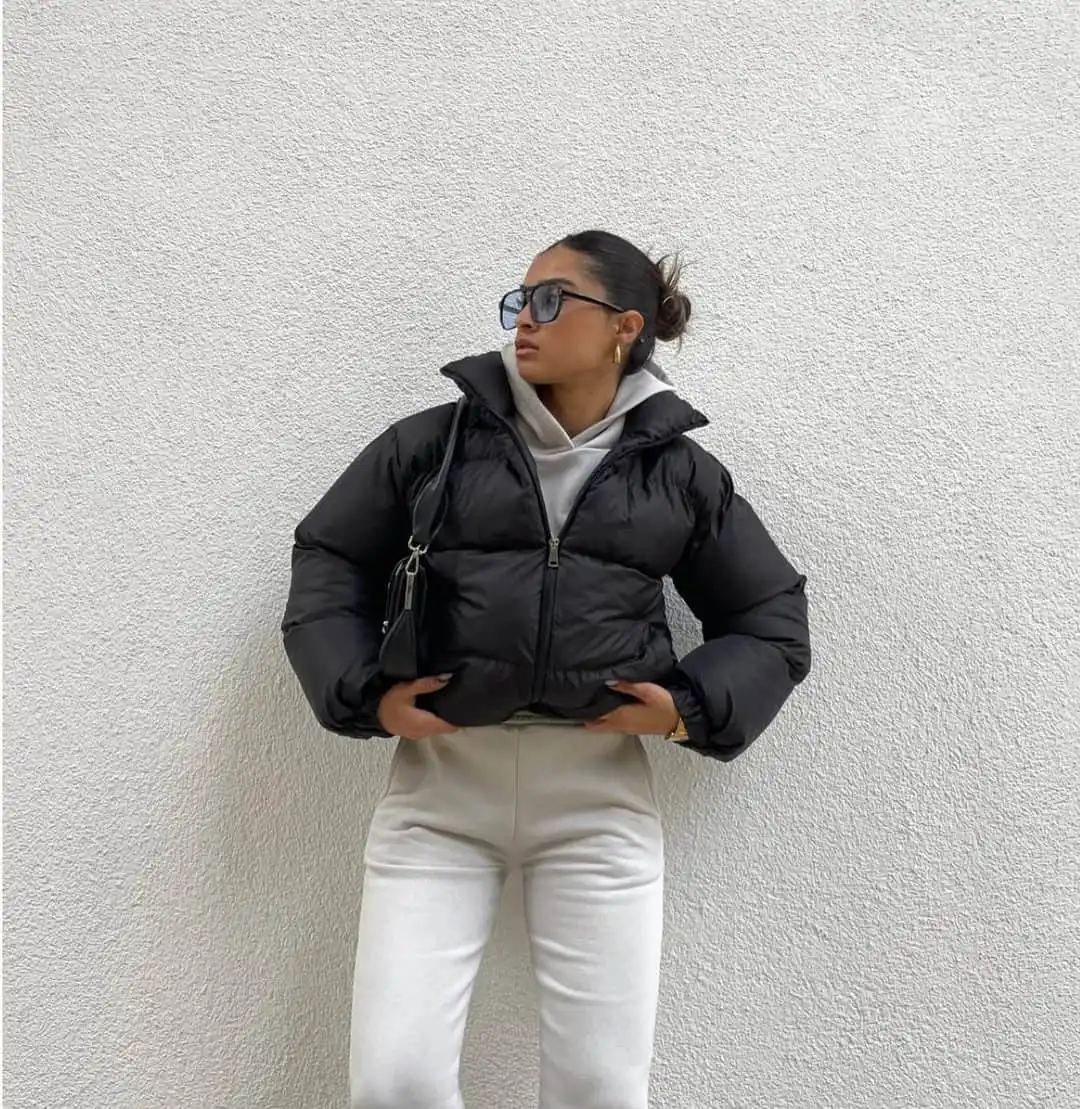 Woman in a cropped puffer jacket winter street style