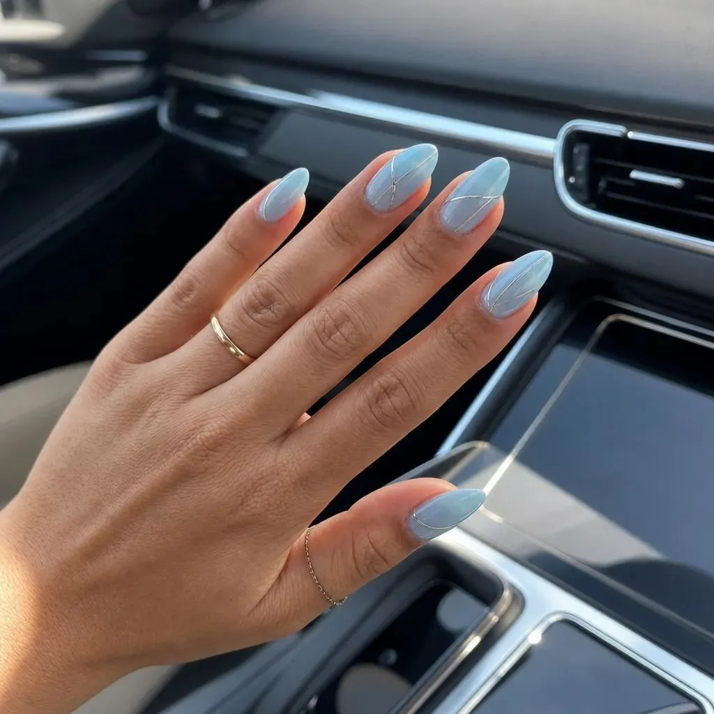 Summer June Nails 2026 Icy Blue Marble Almond Nails With Silver Accents