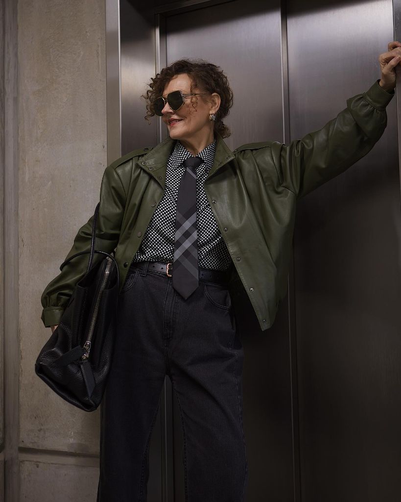 What to Wear This Fall 2026 Over 50 Olive Leather Jacket With Plaid Tie and Dark Denim