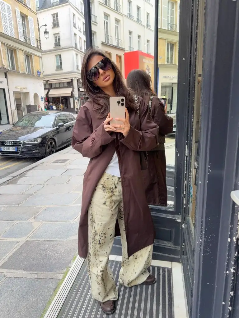 Fall Outfits With Coat 2026 Chocolate Anorak With Paint-Splatter Trousers on a Paris Street