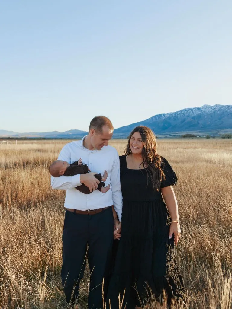 Fall Family Picture Outfits 2026 Black Dress and Open Sky for a New Family of Three