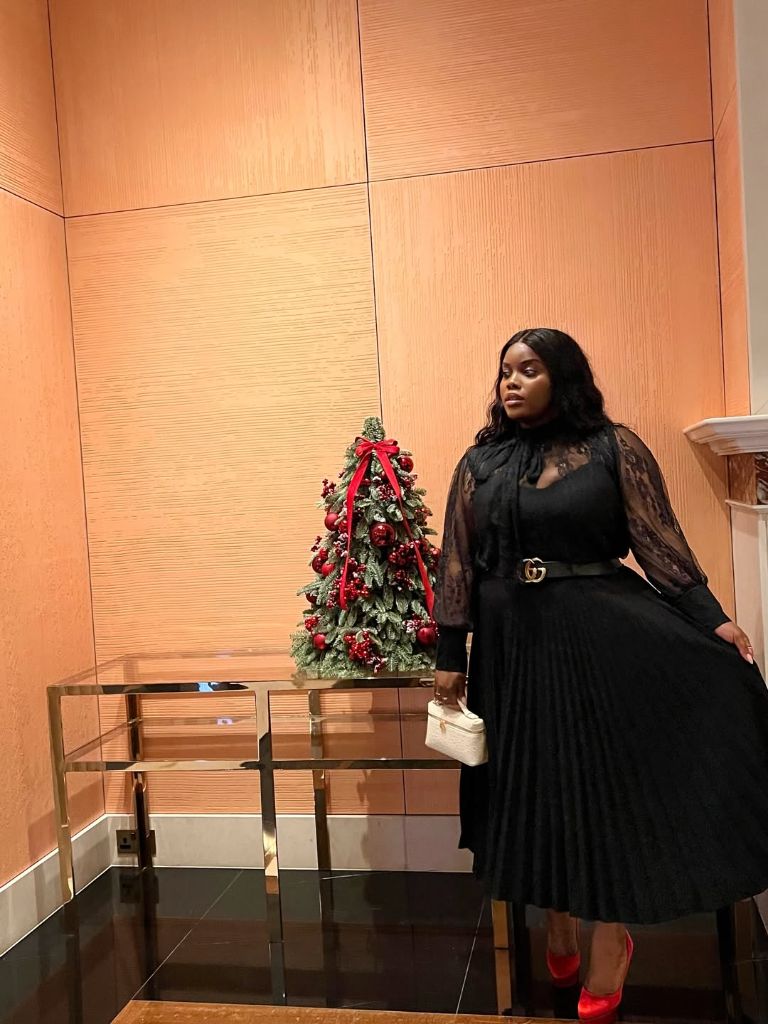 Fall Outfits for Black Women in 2026 Black Lace Blouse With Pleated Midi Skirt for Holiday Cocktails