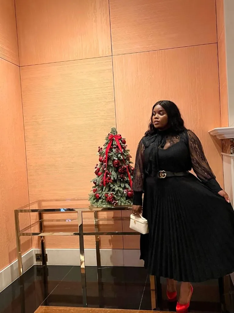 Fall Outfits for Black Women in 2026 Black Lace Blouse With Pleated Midi Skirt for Holiday Cocktails