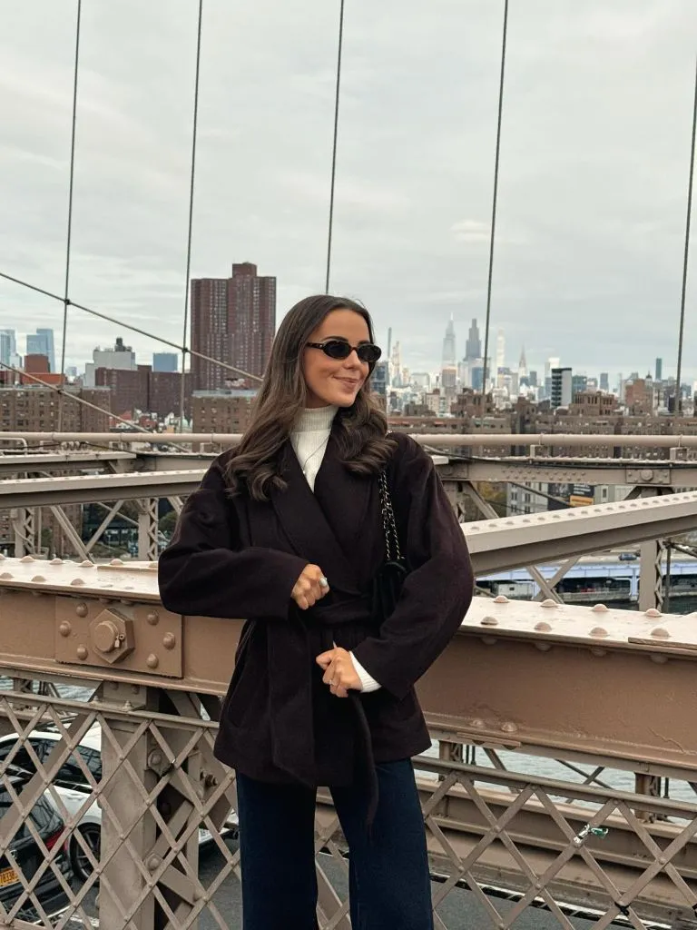 Fall Outfits With Coat 2026 Dark Plum Wrap Coat on the Brooklyn Bridge
