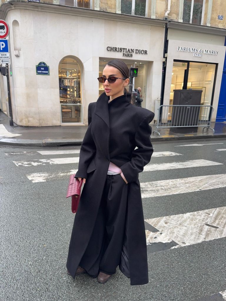Fall Outfits With Coat 2026 Sculptural Black Coat With a Pink Clutch on Rue Saint-Honoré