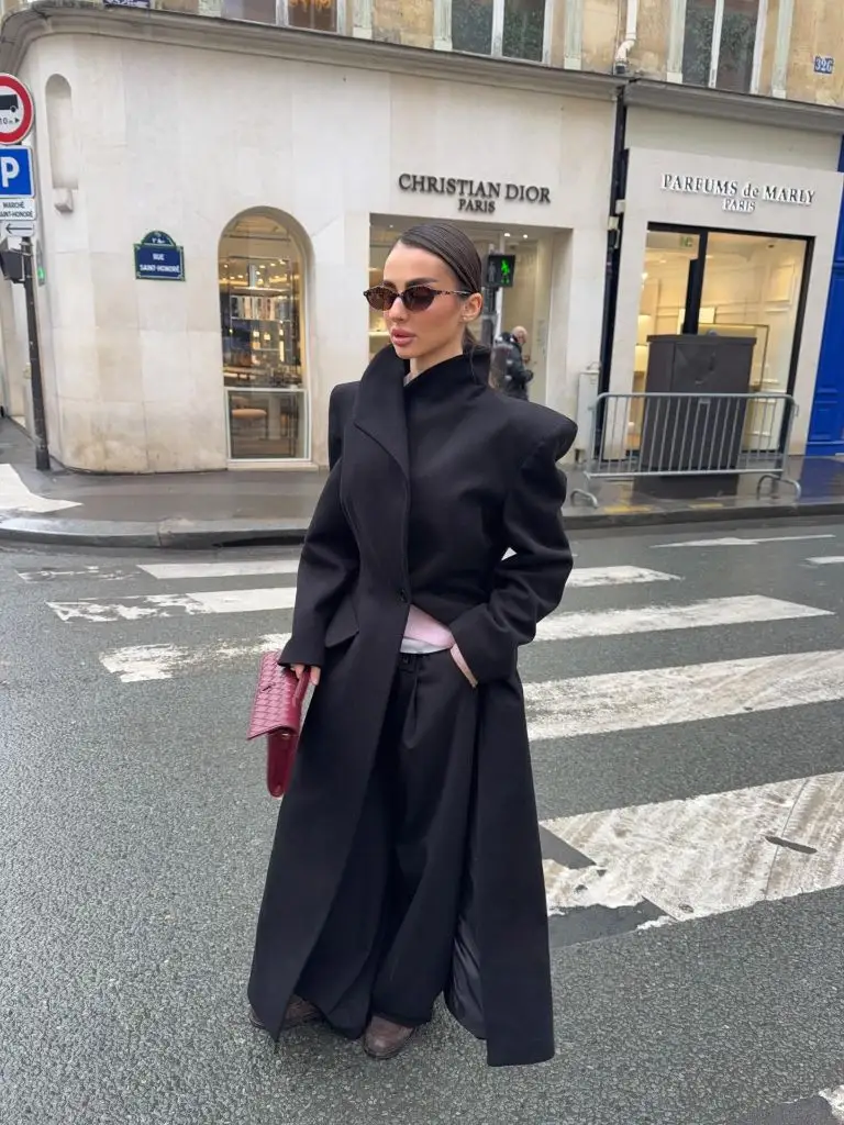 Fall Outfits With Coat 2026 Sculptural Black Coat With a Pink Clutch on Rue Saint-Honoré