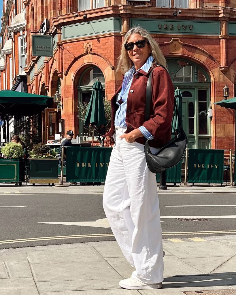 What to Wear This Fall 2026 Over 50 Burgundy Cropped Jacket With Striped Shirt and White Pants