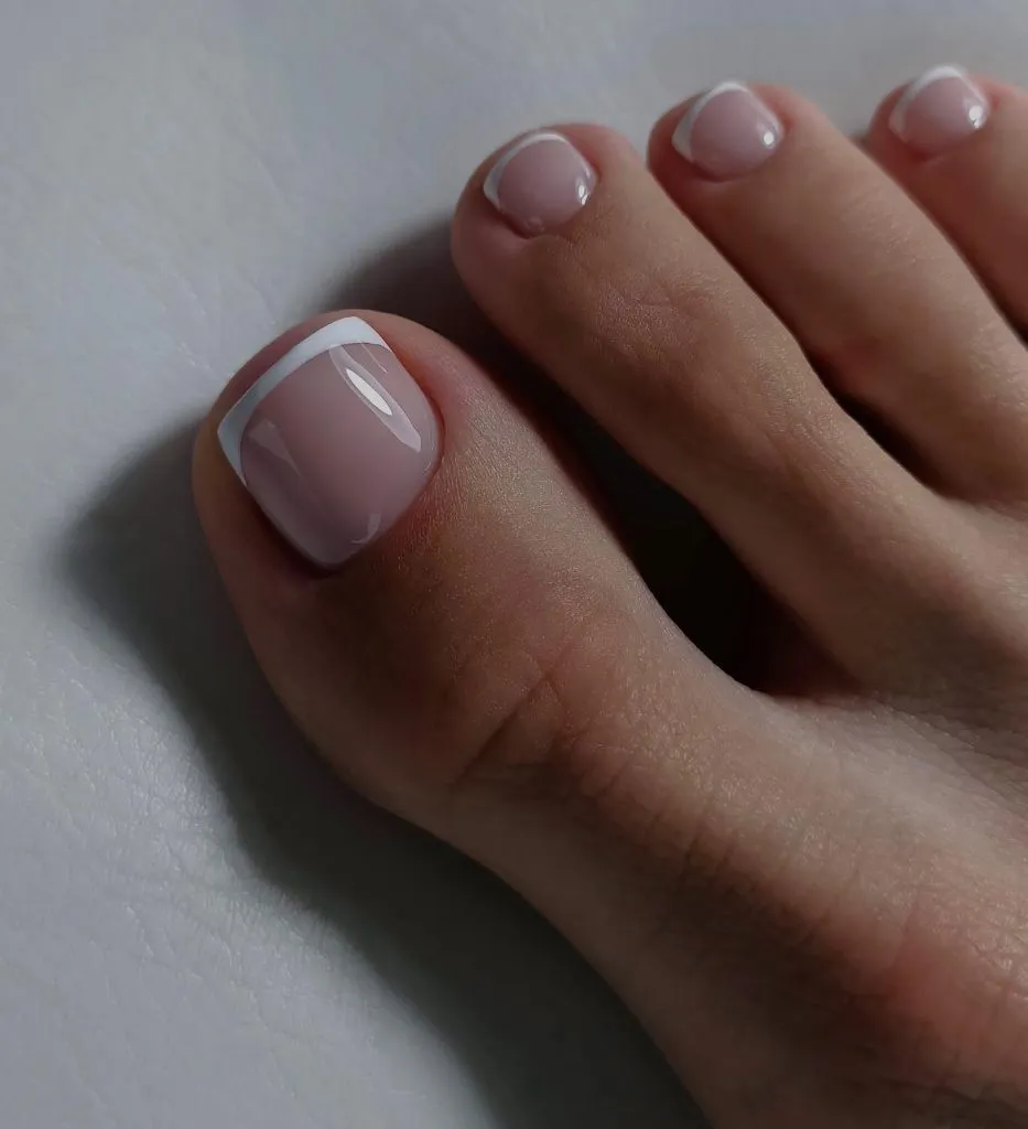 August Pedicure Nails Ideas 2026 Classic White French Tip Toes With a Glossy Nude Base