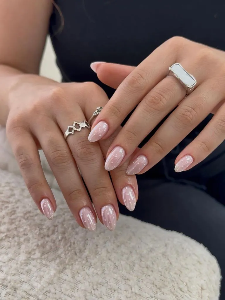 August Nails Ideas 2026 Sheer Pink Almond Nails With White Speckle Detail