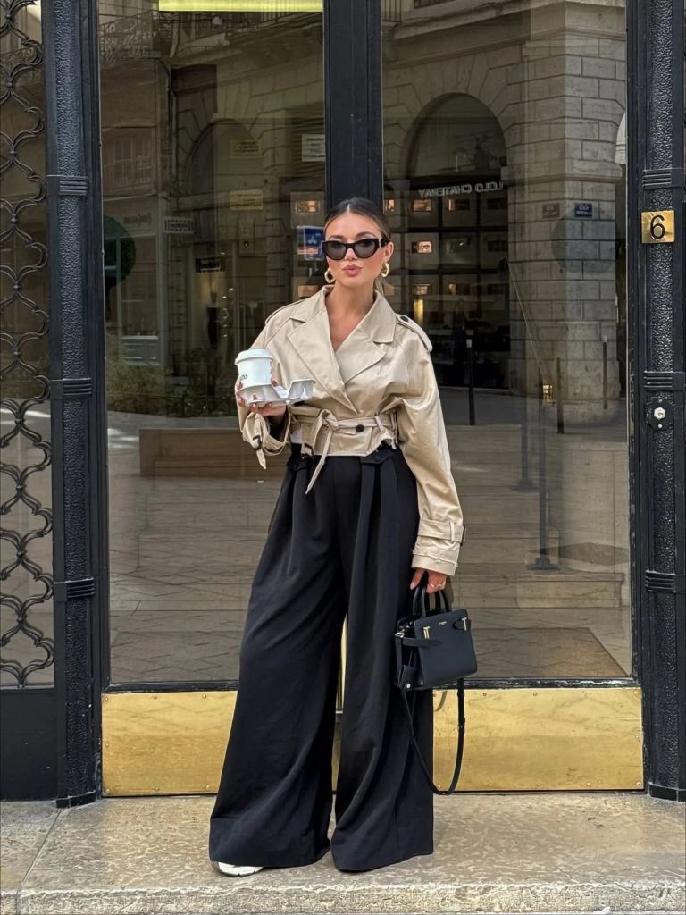 Nice Fall Outfits 2026 Cropped Beige Trench With Black Wide-Leg Pants and a Structured Bag