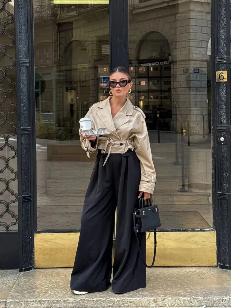Nice Fall Outfits 2026 Cropped Beige Trench With Black Wide-Leg Pants and a Structured Bag