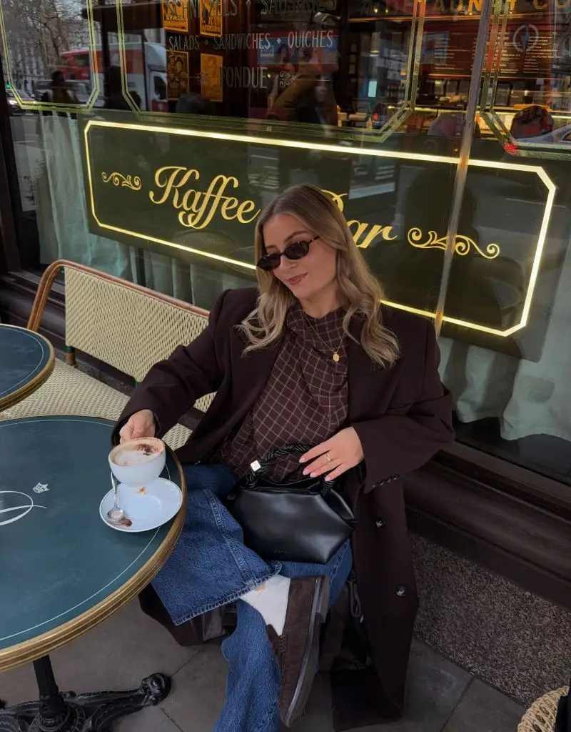 Wide Leg Jeans Outfit Fall 2026 Chocolate Blazer and Plaid Shirt at a Kaffee Bar