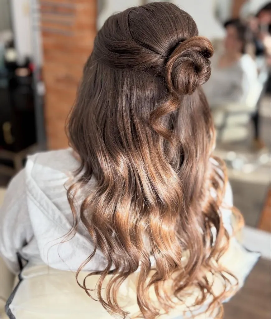 Fall Hairstyles for Wedding Guests 2026 Sophisticated Half-Up Bun with Sunlit Balayage Waves
