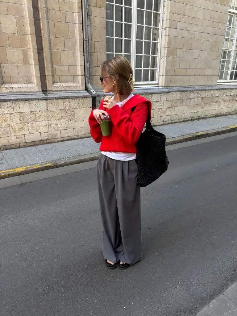 August Outfits 2026 Red Cropped Sweater Over White Tee With Wide Grey Trousers