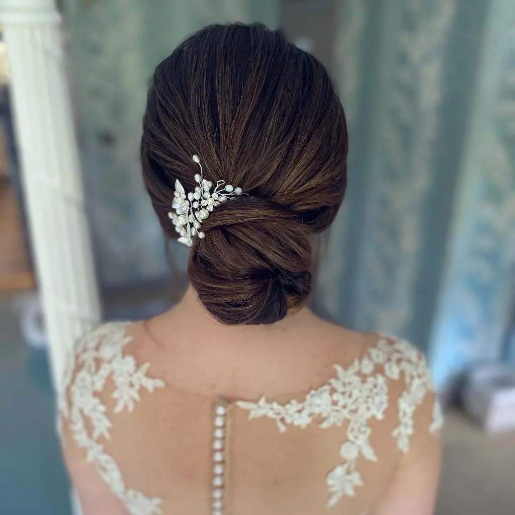 Fall Hairstyles for Wedding Guests 2026 Classic Low Chignon with Delicate Pearl Hairpiece