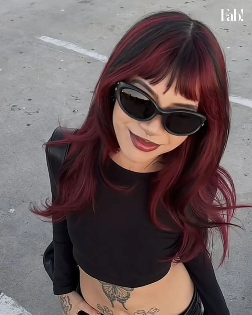 August Hairstyles And Color Ideas 2026 Glossy Cherry Cola Red With Wispy Bangs