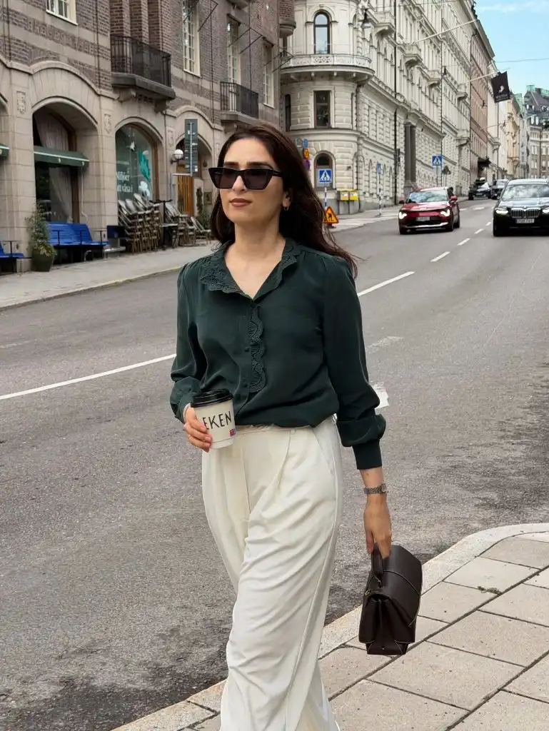 Midi Skirt Fall Outfit 2026 Forest Green Ruffle Blouse With Cream Trousers And Coffee