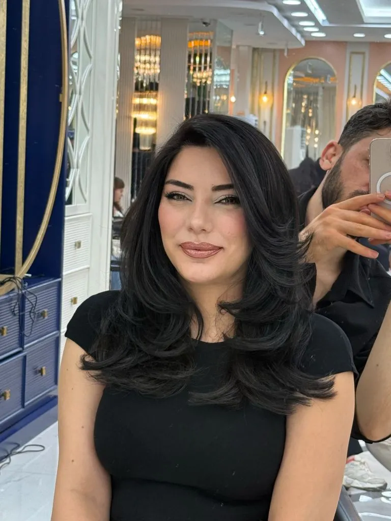 Fall Haircuts for Women 2026 Voluminous Black Blowout With Side-Swept Layers