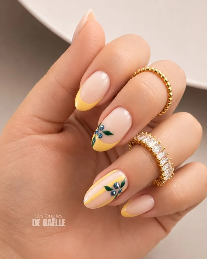 August Nails Ideas 2026 Yellow French Tips With Blueberry Art on Nude Oval Nails