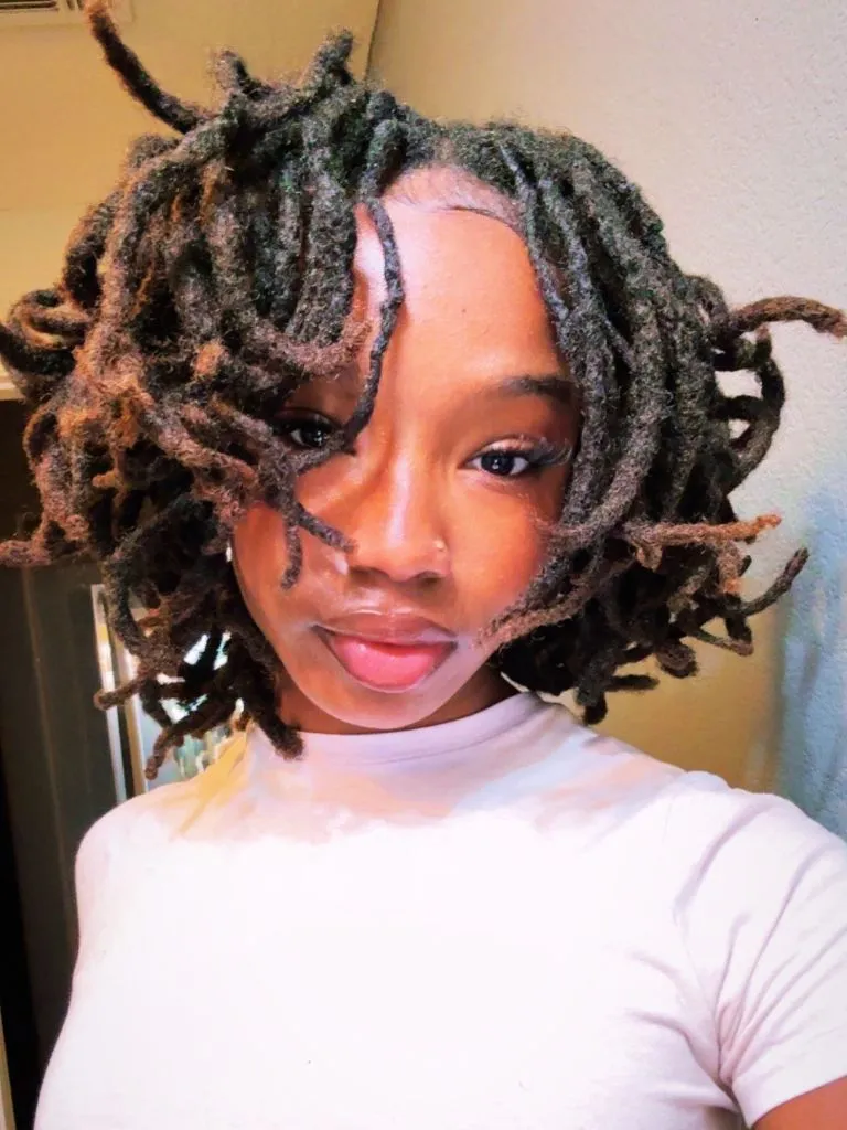 Locs Hairstyles for Black Women 2026 Voluminous Curly Loc Bob with Warm Brown Dimension