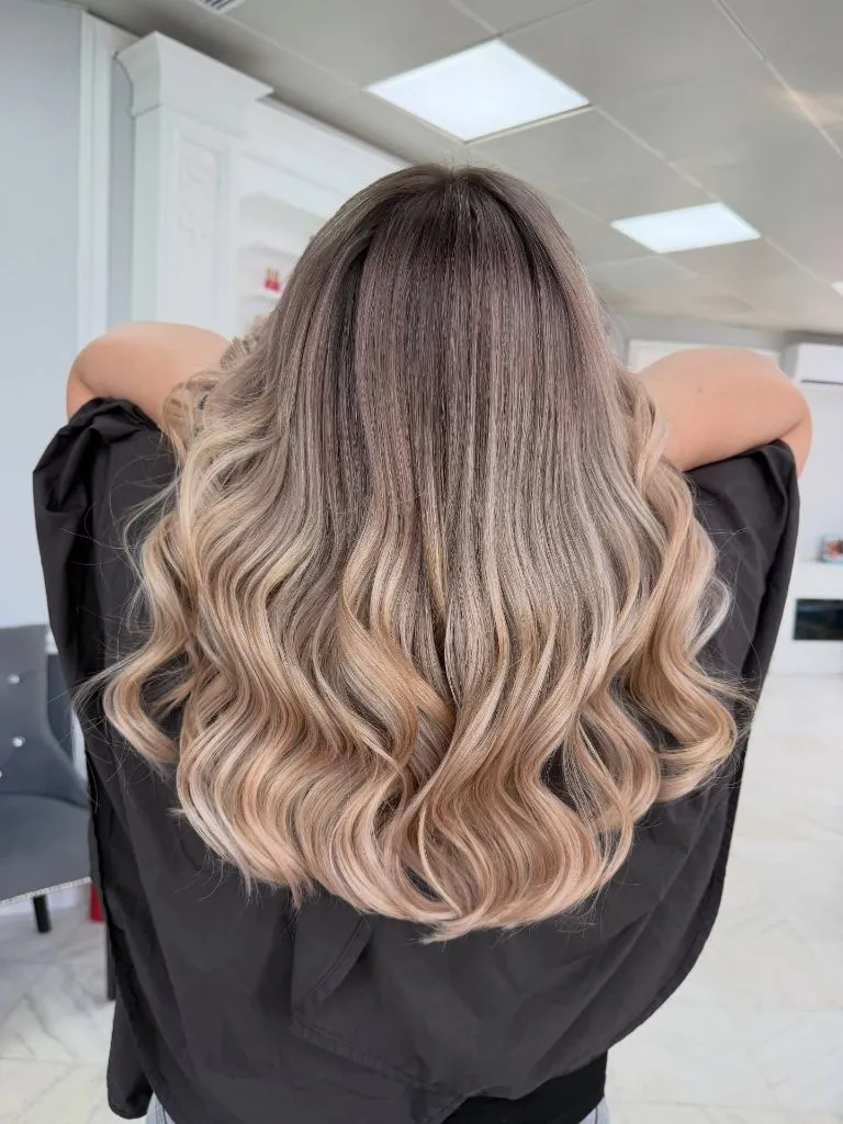Fall Blonde Hair Colour 2026 Brunette-to-Blonde Ombré with Bouncy Curled Ends
