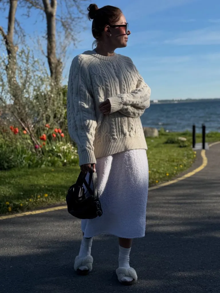 Knit Skirt Outfits Fall 2026 Cream Cable-Knit Sweater With a White Boucle Midi for Full Texture