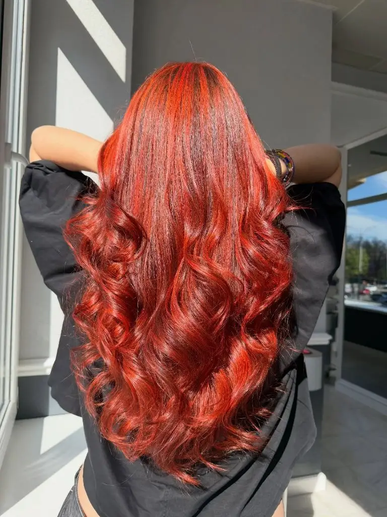 Fall Hair Colour Ideas 2026 Fiery Red with Long Voluminous Curls That Carry Every Room