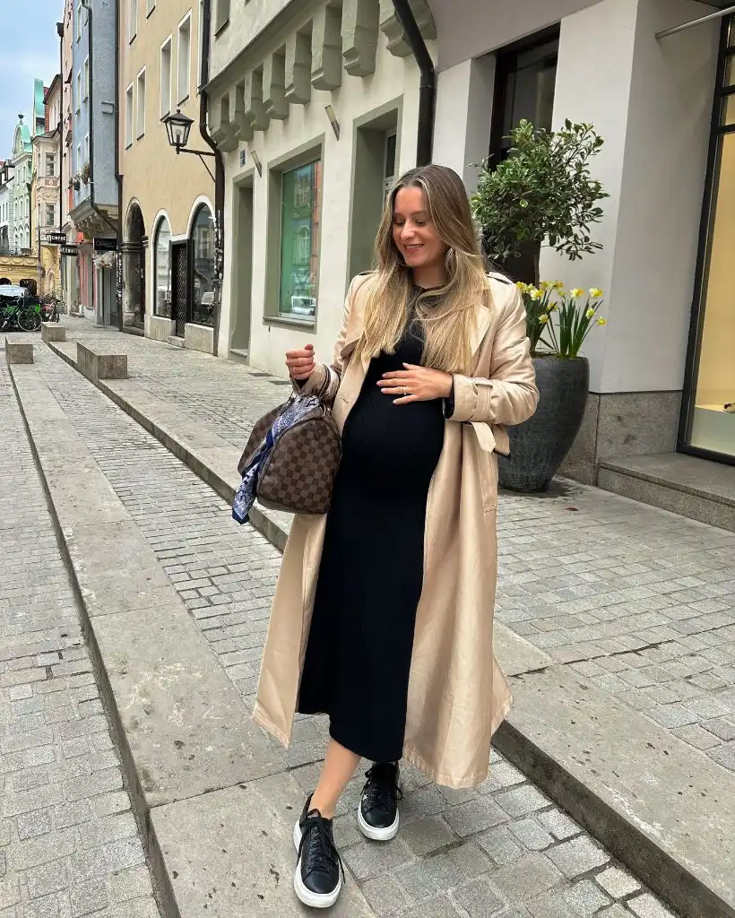 Fall Pregnancy Outfits 2026 Black Ribbed Midi Dress With a Champagne Trench