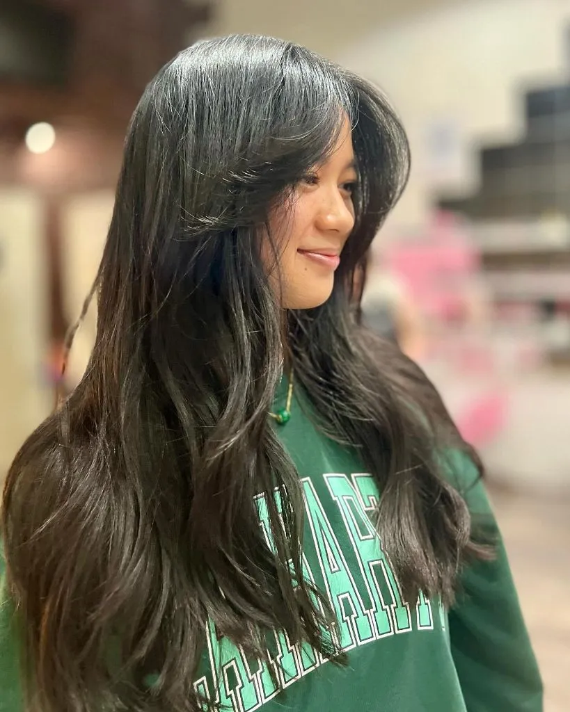 Fall Hairstyles for Long Hair 2026 Jet Black Butterfly Layers with Wispy Curtain Bangs