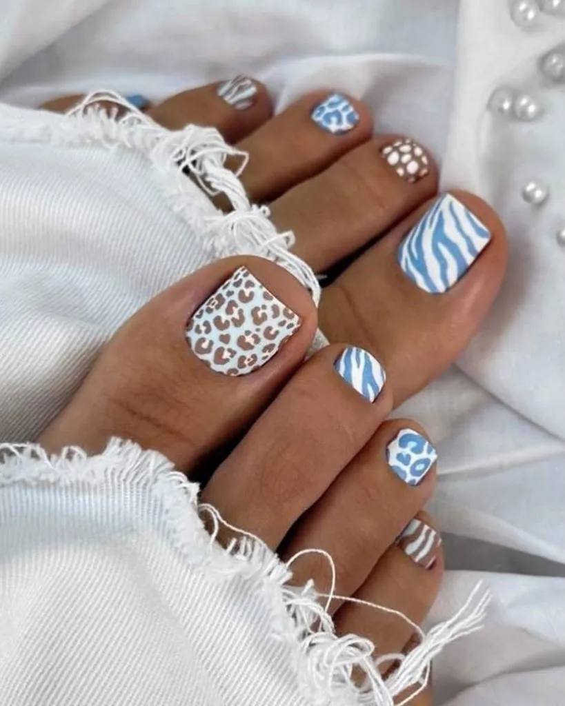 August Pedicure Nails Ideas 2026 Blue and White Animal Print Mix for a Patterned August Pedicure