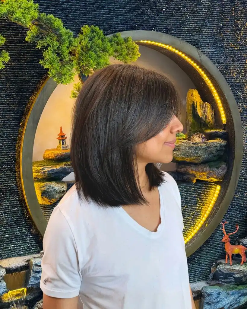 Fall Hairstyles for Short Hair 2026 Angled Layered Lob with Textured Side-Swept Bangs