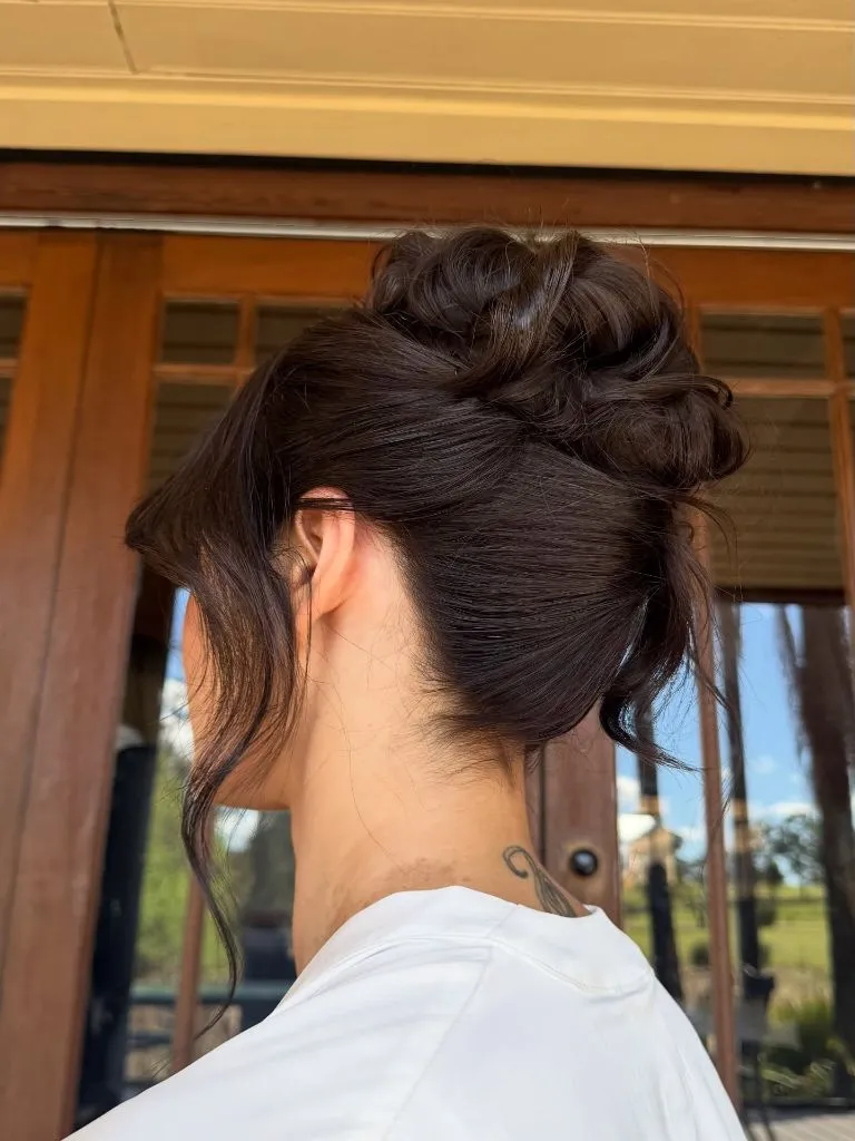 Fall Hairstyles for Wedding Guests 2026 Effortless Brunette High Bun with Face-Framing Wisps
