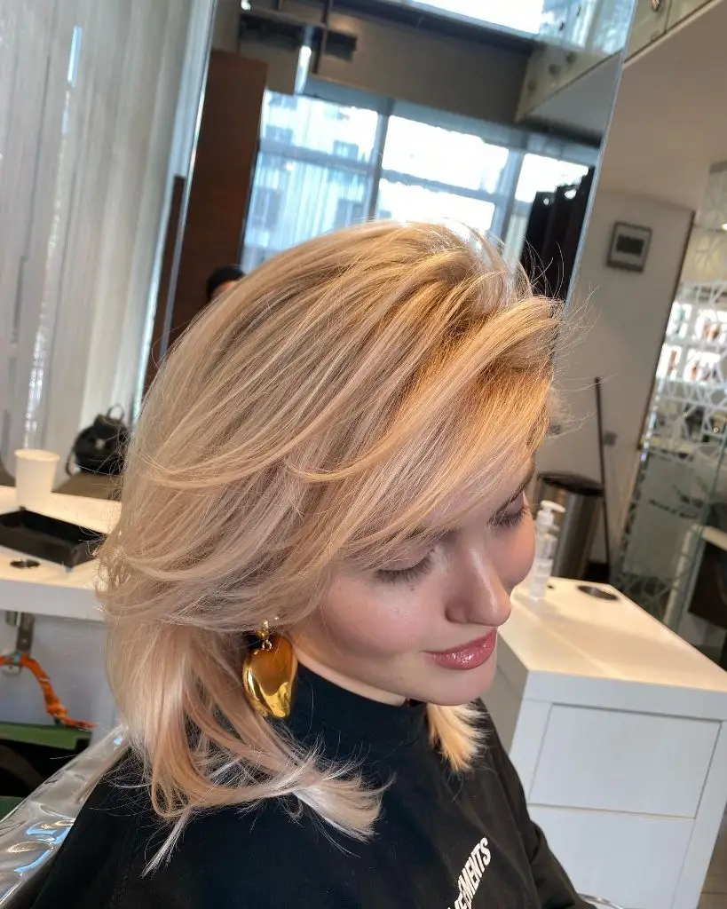 Fall Medium Haircuts 2026 Golden Blonde Layered Shag With Curtain Bangs and Movement