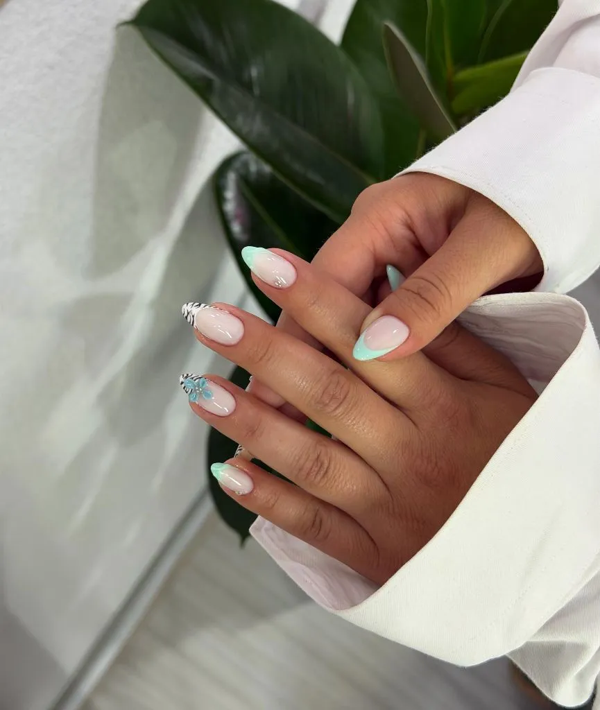 August Nails Ideas 2026 Mint French Tips With Zebra Accent and Flower Detail