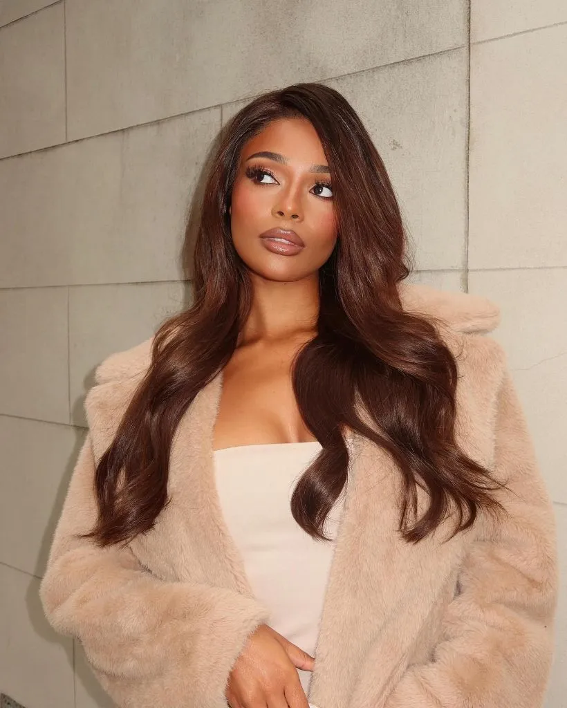 Fall Hair Colors for Black Women 2026 Chocolate Brunette Blowout with Faux Fur Coat