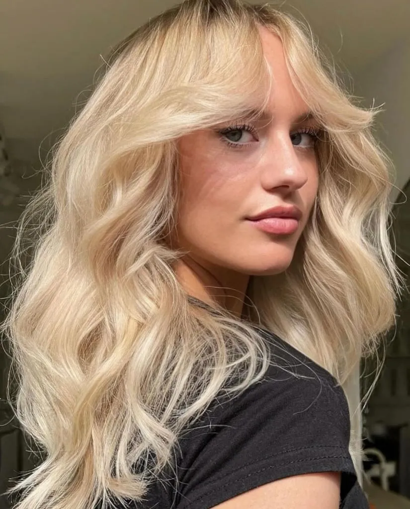 Fall Hairstyles for Office 2026 Lived-In Beach Waves with Curtain Bangs and Blonde Glow