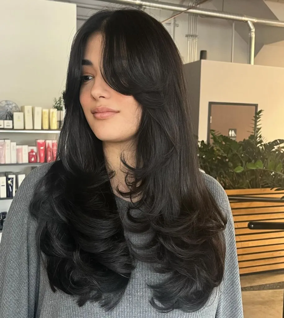 Fall Hairstyles 2026 Jet Black Butterfly Layers with Curtain Bangs for Maximum Volume