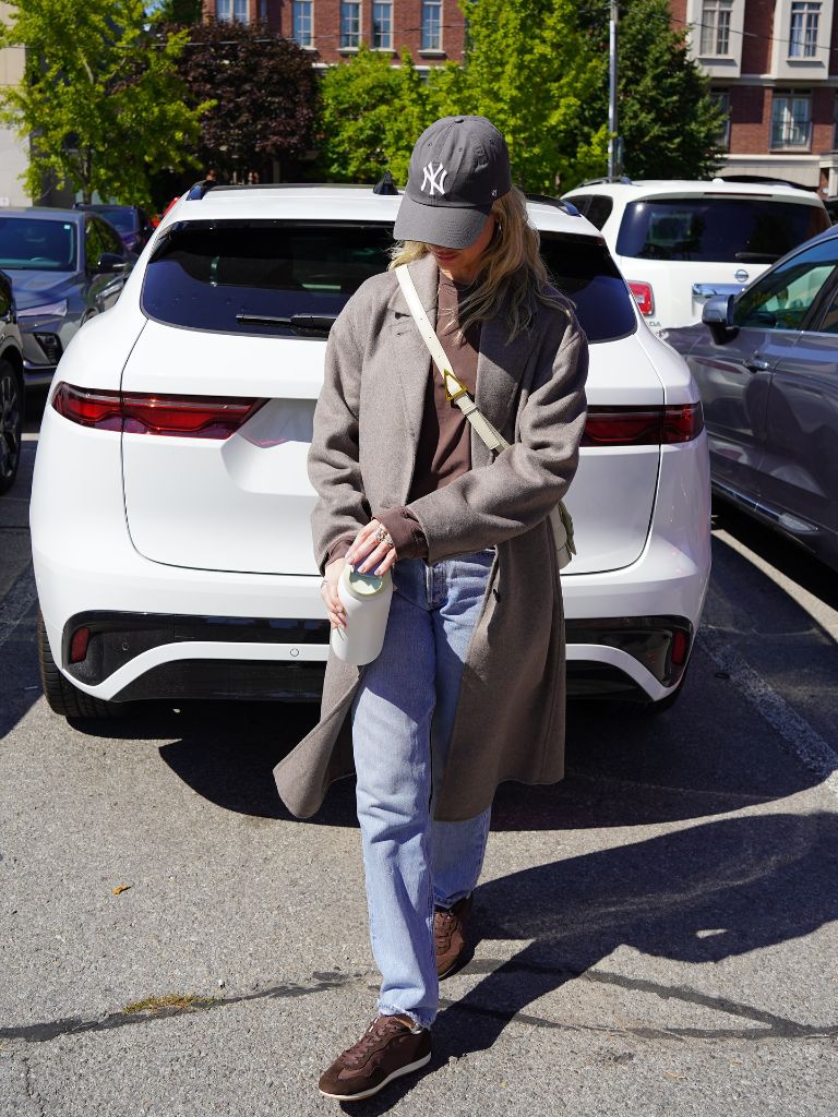 Nice Fall Outfits 2026 Taupe Overcoat With a Hoodie and Relaxed Jeans for Casual Cool