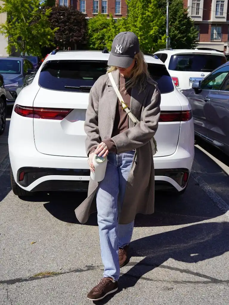 Nice Fall Outfits 2026 Taupe Overcoat With a Hoodie and Relaxed Jeans for Casual Cool