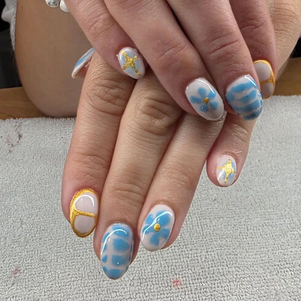 August Nails Color 2026 Sky Blue and Gold Floral Nails for a Whimsical Short-Nail August Set