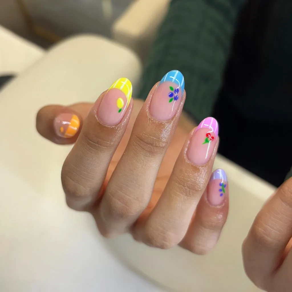 August Nails Ideas 2026 Rainbow Pastel French Tips With Fruit Art on Oval Nails