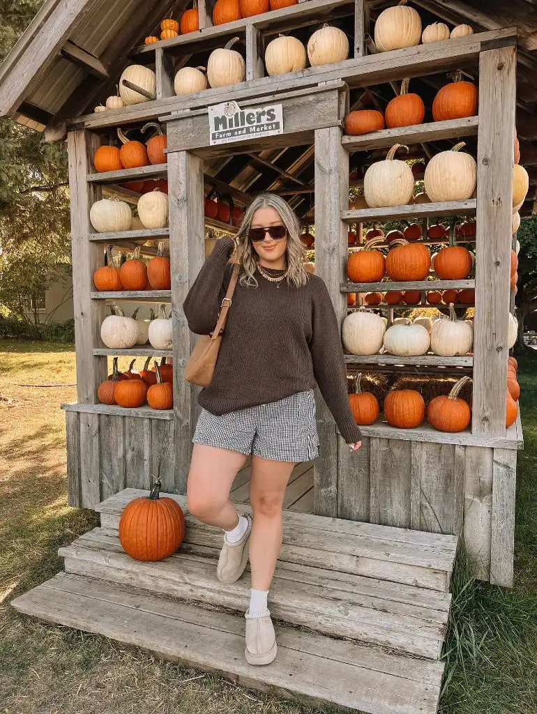 Comfy Fall Outfits 2026 Oversized Brown Sweater and Gingham Shorts at the Pumpkin Patch