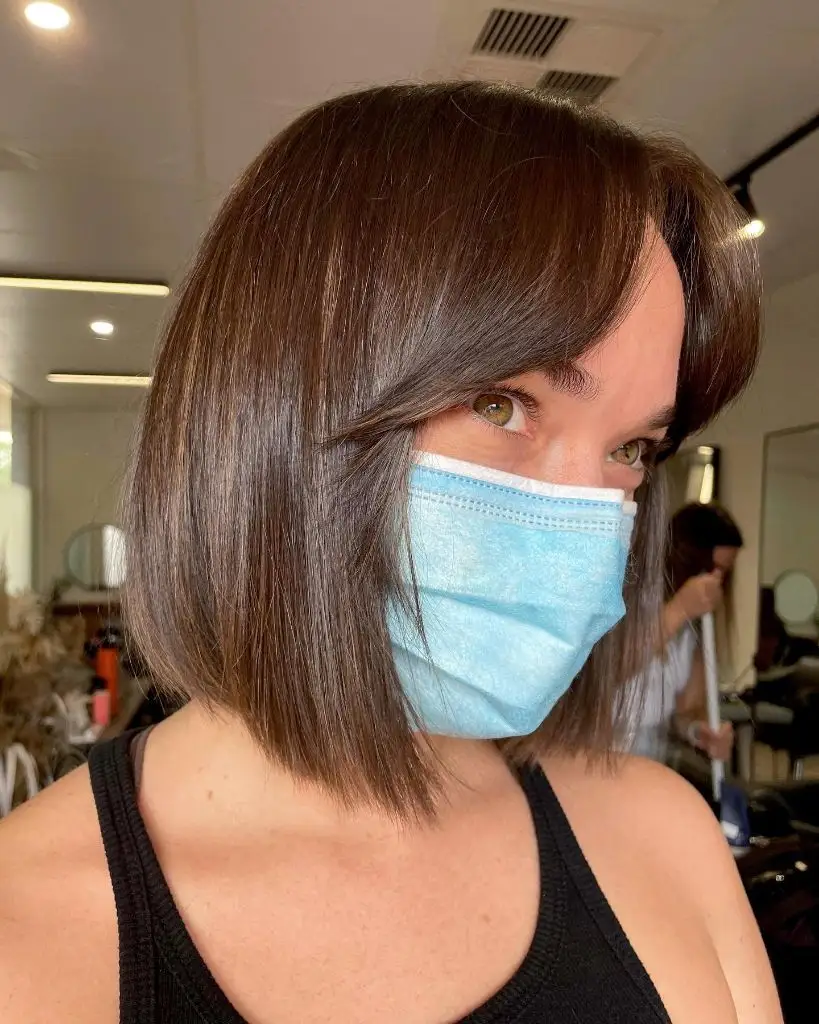 Fall Hairstyles for Short Hair 2026 Smooth Brunette Chin Bob with Curtain-Swept Bangs