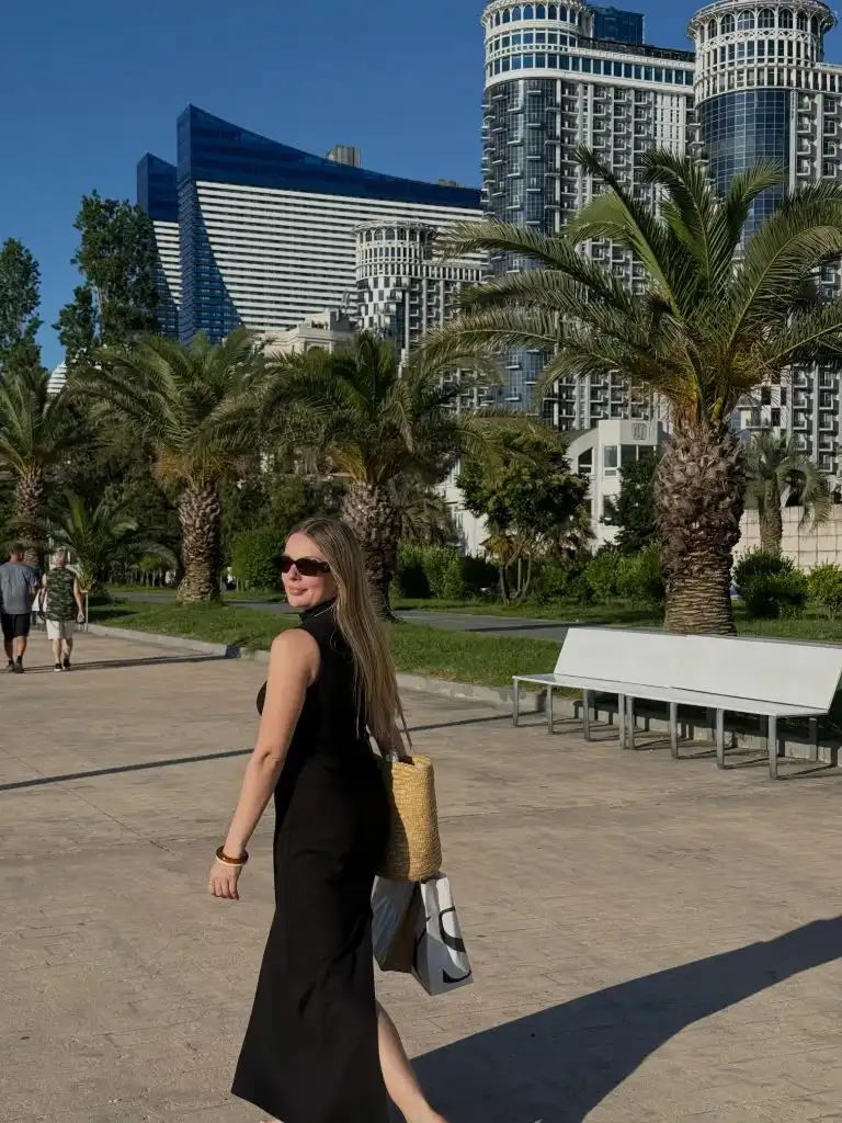 Fall Outfits for 2026 Black Halter Dress With Straw Bag in a Warm City