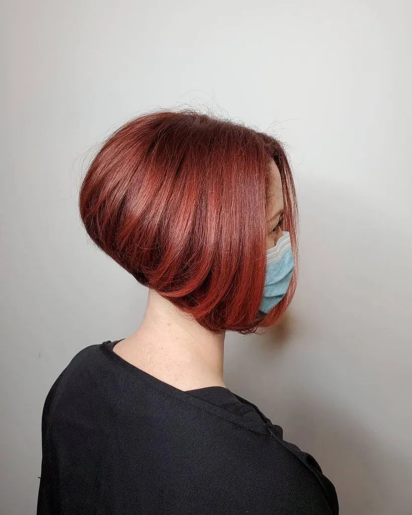Bobbed Haircut for Women 2026 Warm Auburn Stacked Bob with Vintage Volume and Face-Framing Sweep