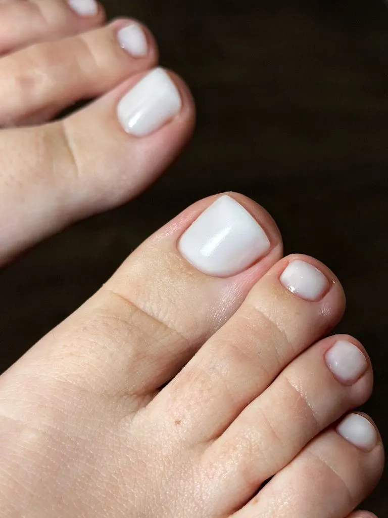 August Pedicure Nails Ideas 2026 Pearly White Pedicure With a Clean Glossy Finish