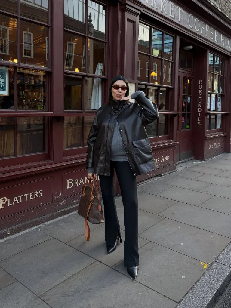 Fall Pregnancy Outfits 2026 Black Leather Jacket Over a Grey Sweater With Flared Trousers