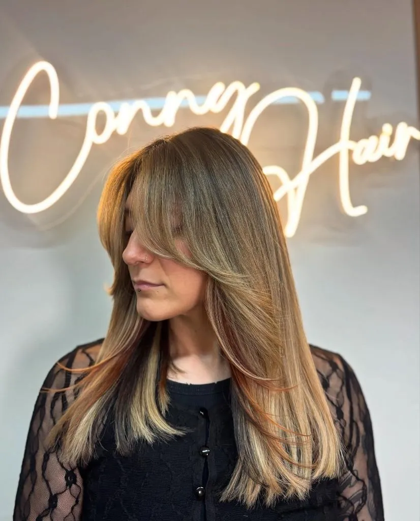 Fall Hair Colour Ideas 2026 Warm Caramel Bronde with Layered Curtain Bangs
