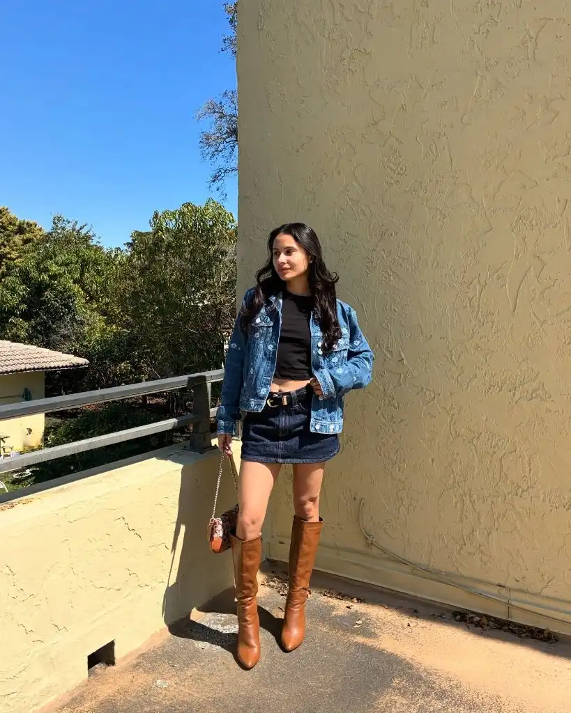 Nice Fall Outfits 2026 Denim Jacket and Mini Skirt With Cognac Tall Boots for a Western Twist