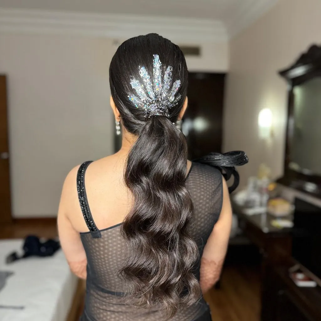 August Hairstyles And Color Ideas 2026 Sleek Low Ponytail With Body Wave And Glitter Accent